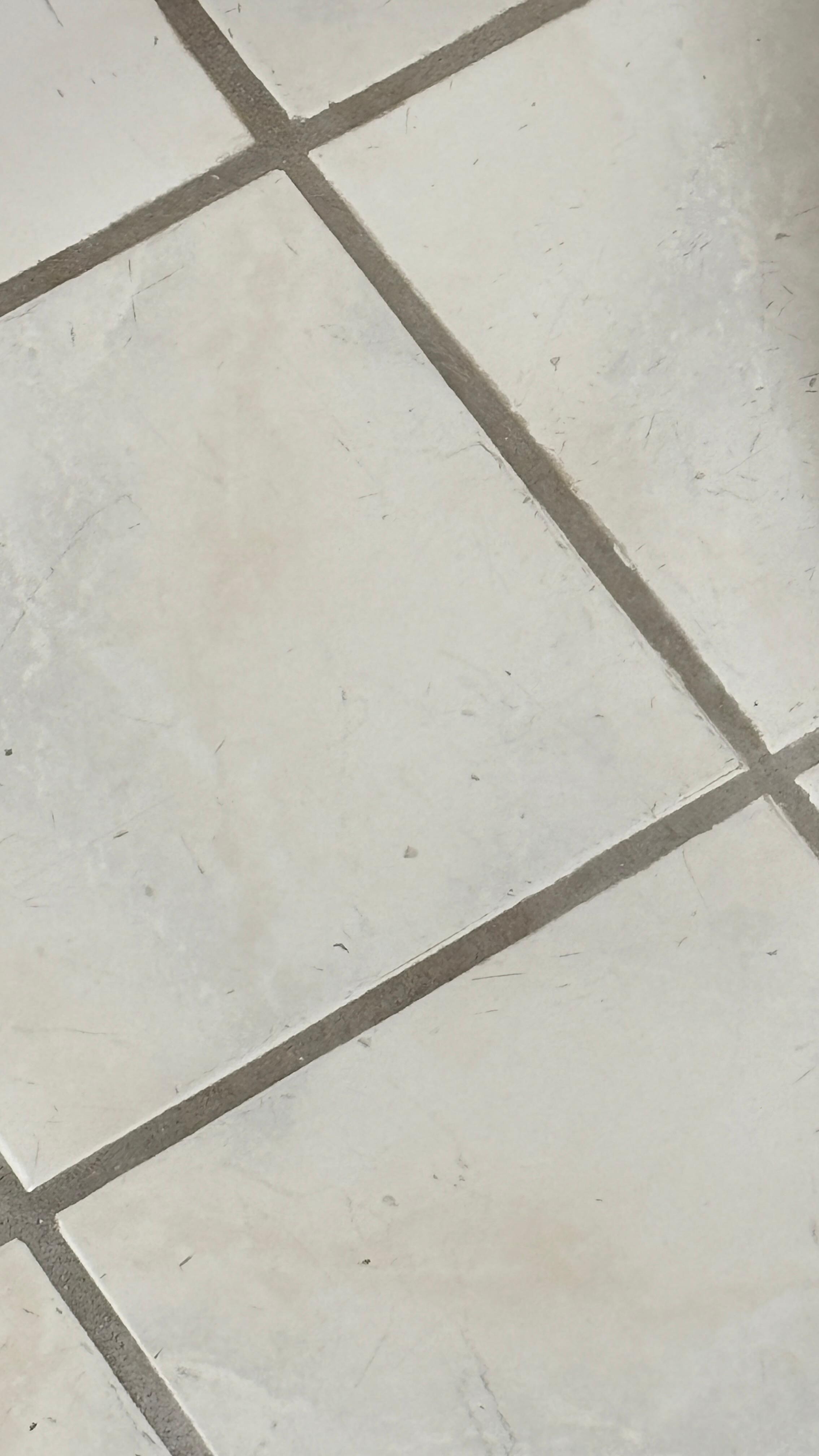 mans shaving on floor of bathroom 