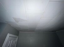 Ceiling in the game room. Stained from previous leaks and wet from the leak that happened while we were there.