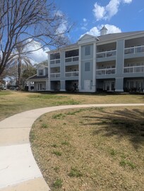 Far left of building with large patio.