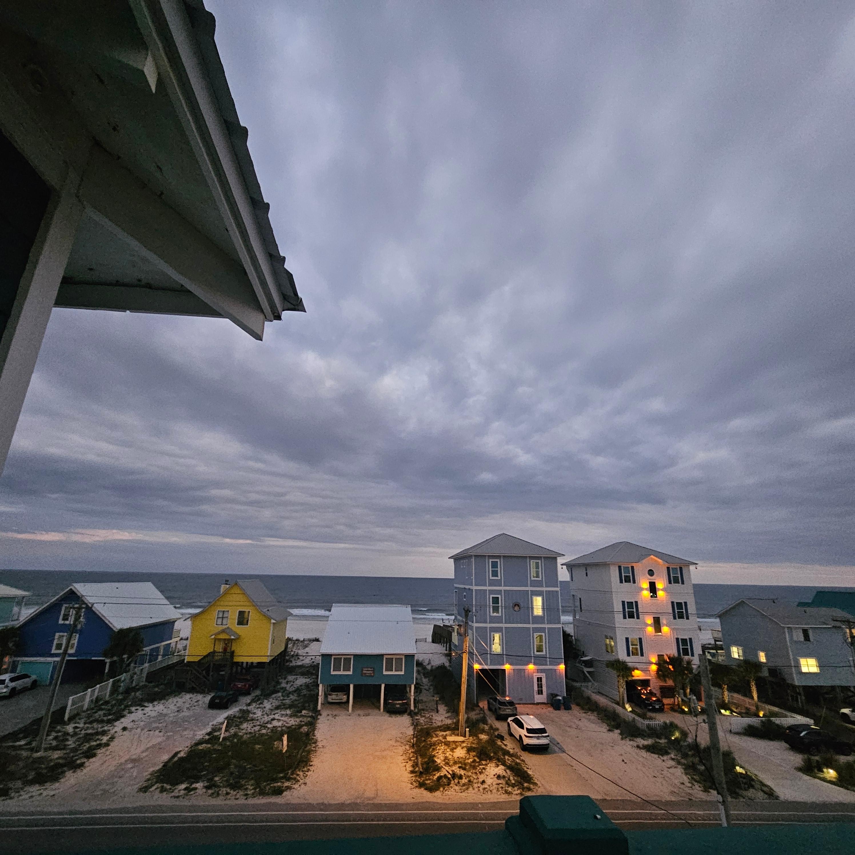 Night view from top floor balcony of ocean.