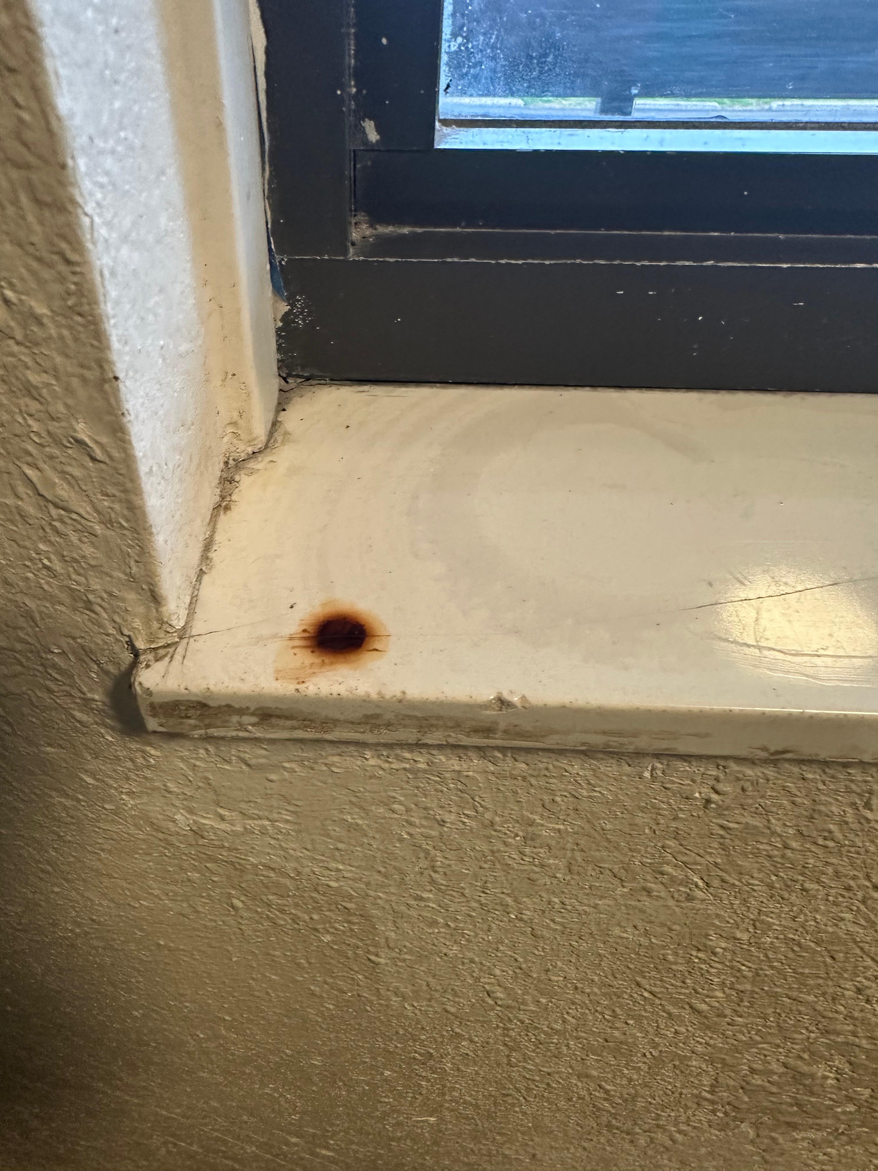 Cigarette stain on window sill