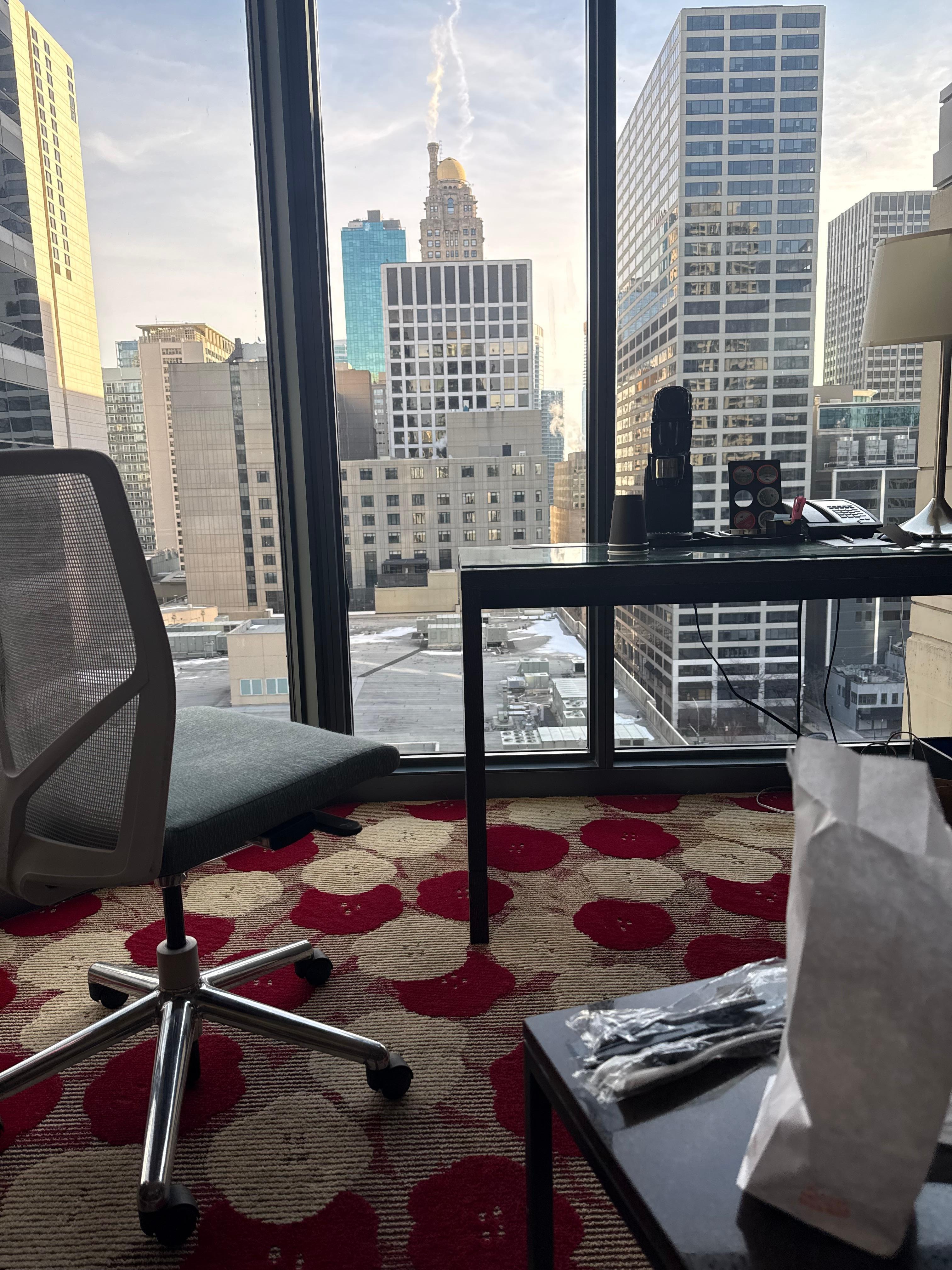 Sitting area includes desk/chair, television, small tables chair and sleeper sofa. 