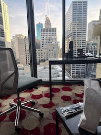 Sitting area includes desk/chair, television, small tables chair and sleeper sofa.