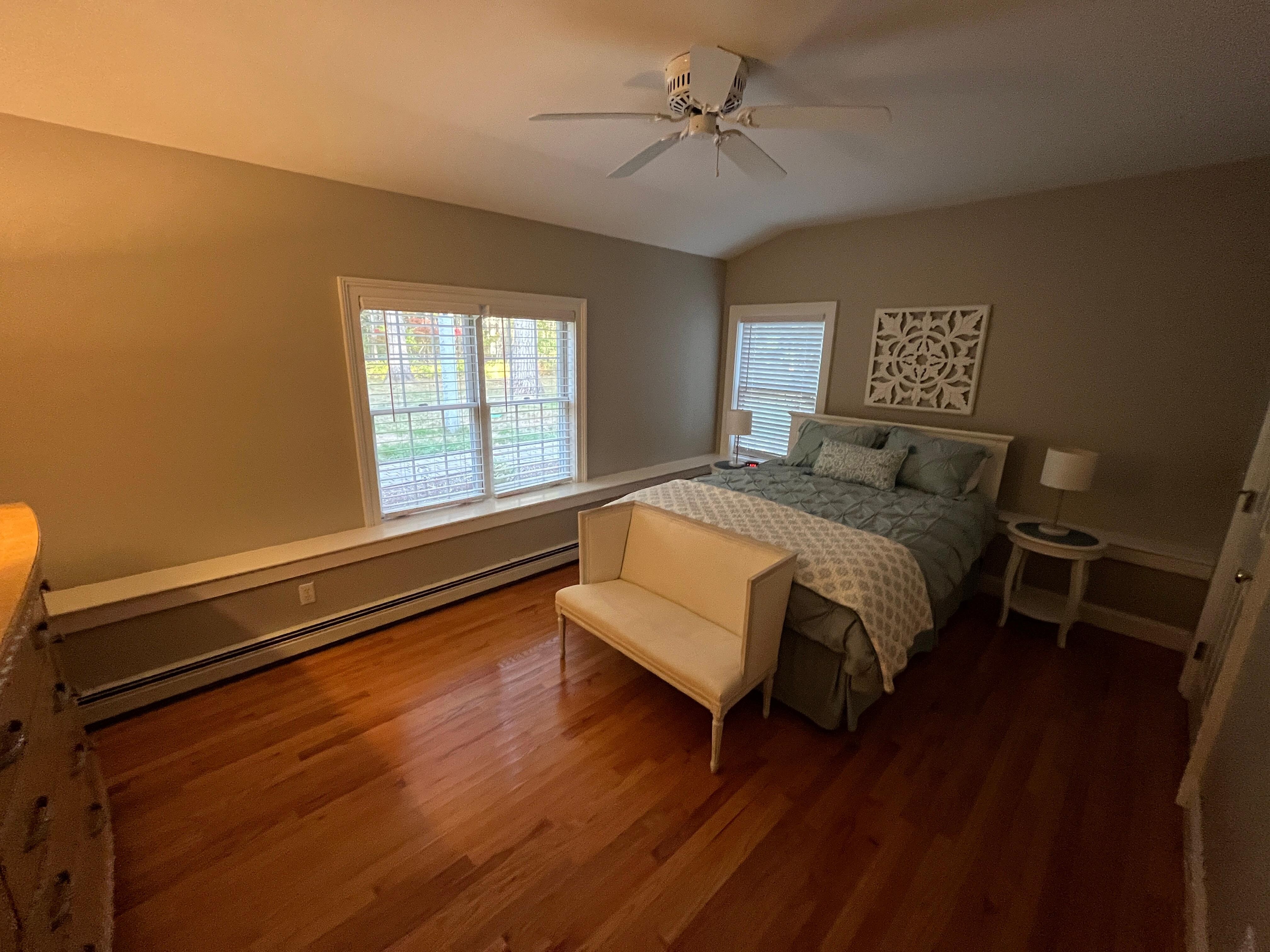 Spacious living room, there is a large walk-in closet to the right with plenty of hanging space and two luggage racks for suitcases. 