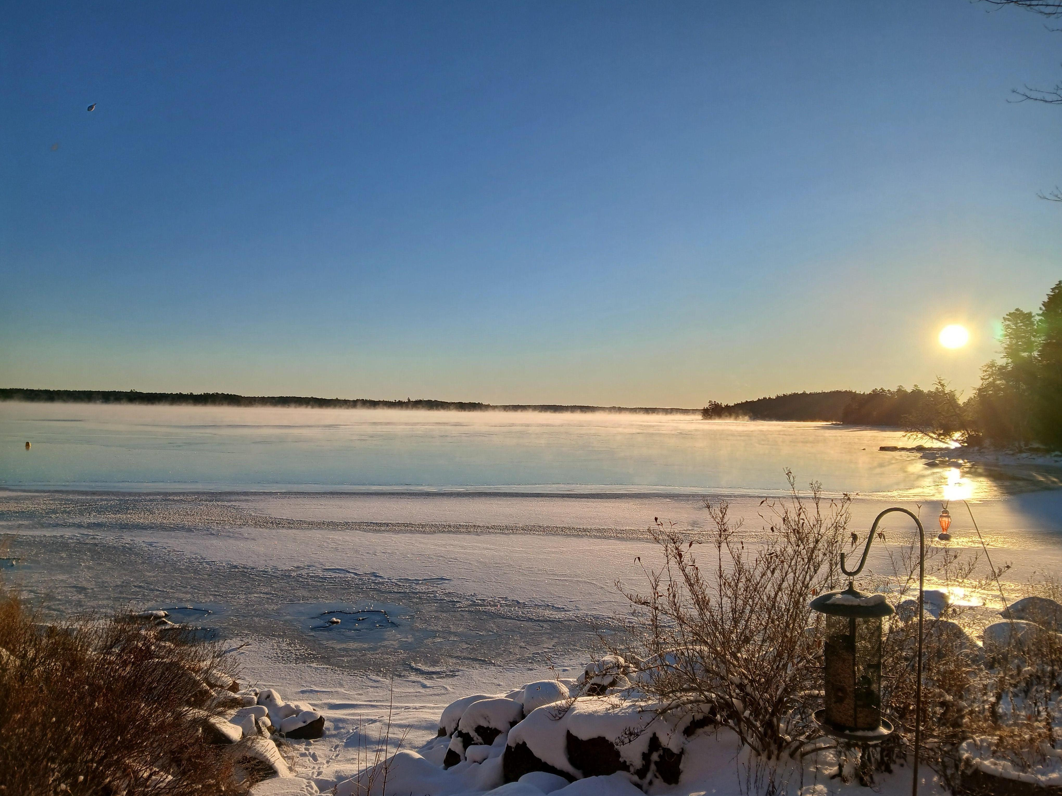 Beautiful frozen lake at sunrise in a very warm and cozy lake house.