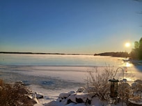 Beautiful frozen lake at sunrise in a very warm and cozy lake house.
