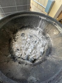 Old used charcoal and ash in bottom of grill