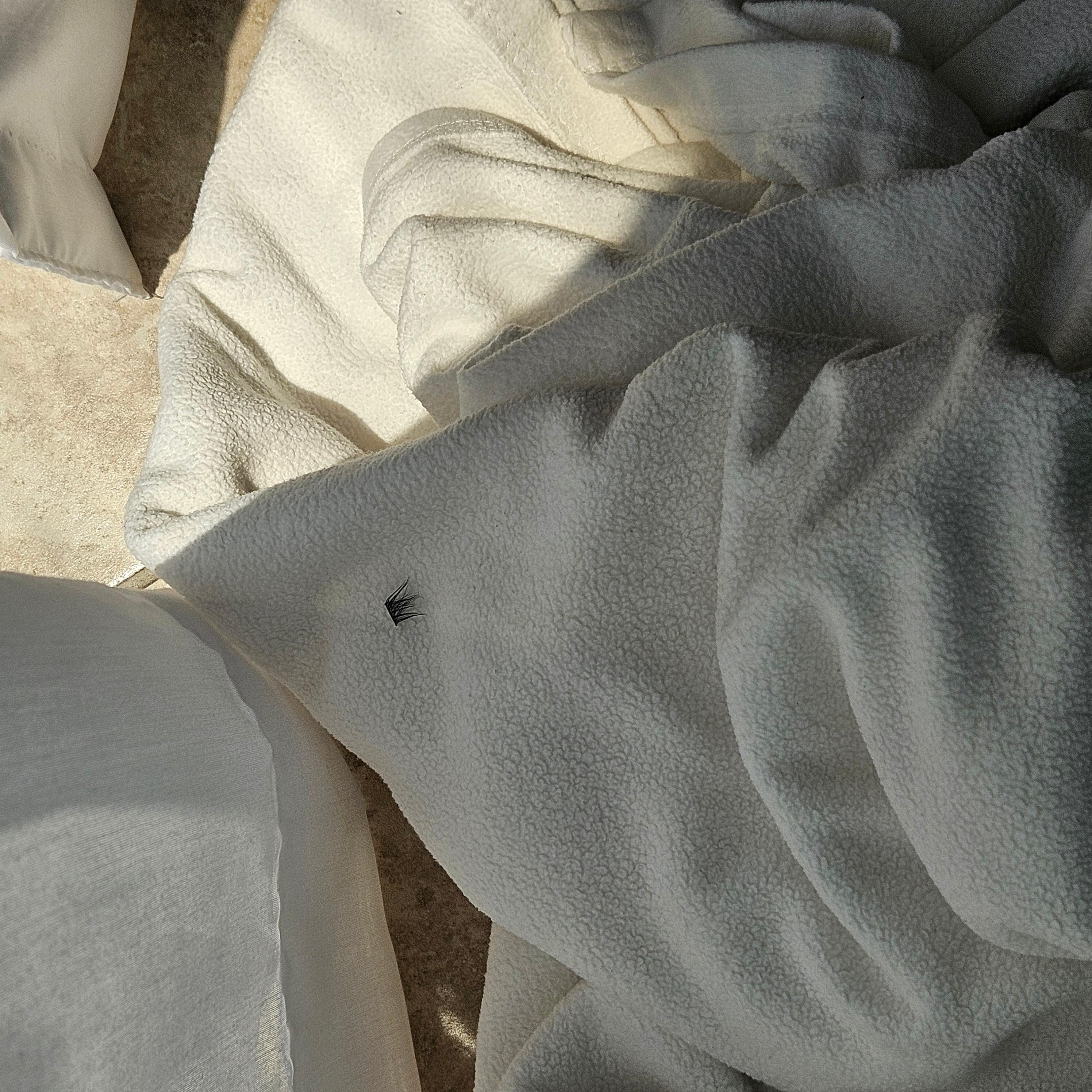See the eyelash extensions stuck to blanket? Not ours!