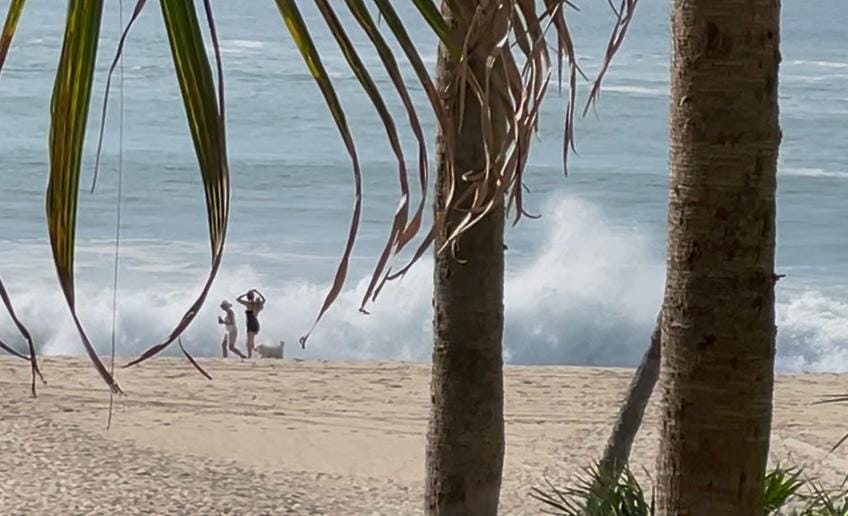 People walking on beach compared to waves- apparently the ocean in the area is quite rough.