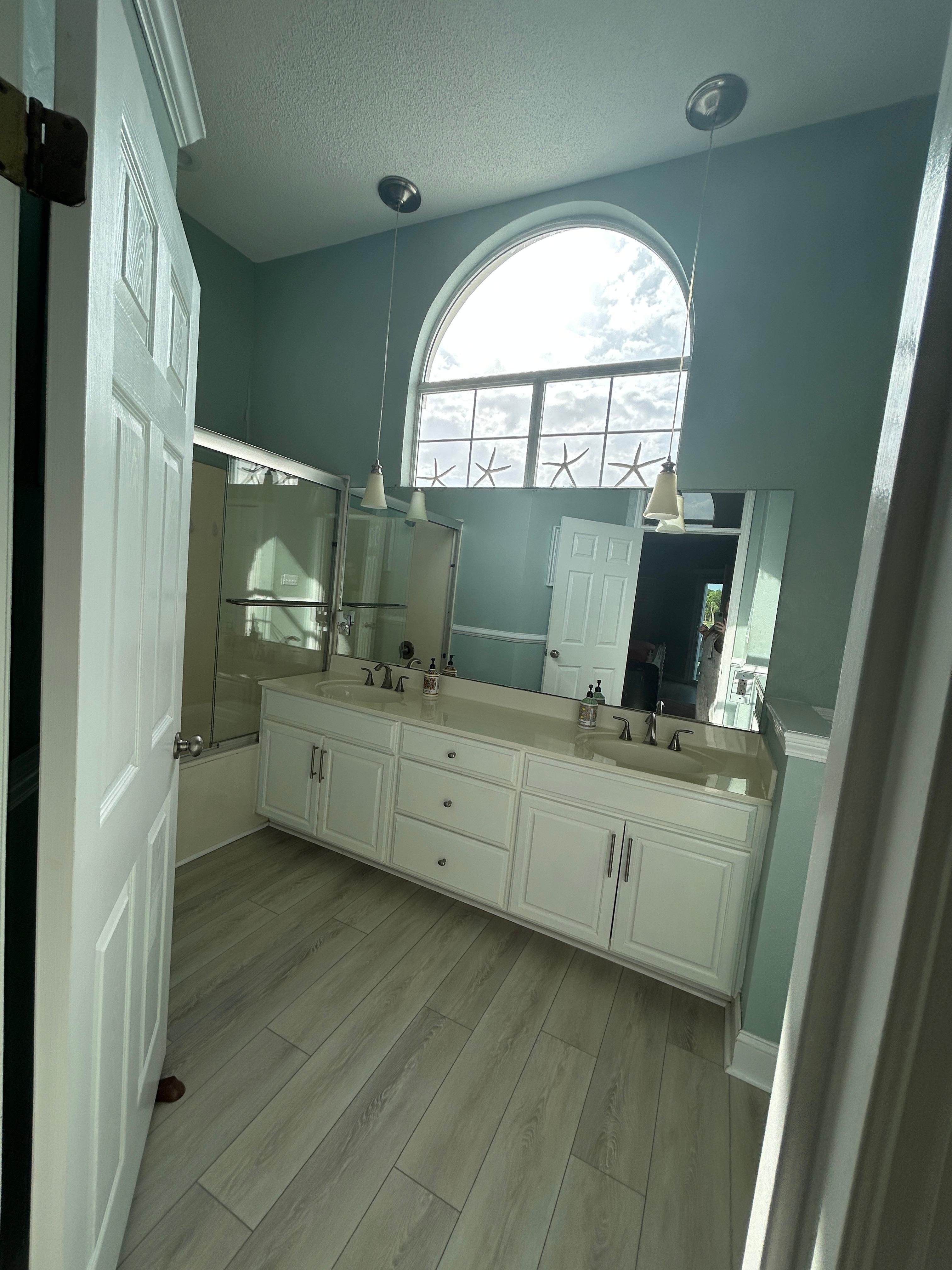 Great lighting and tall ceilings in the upstairs master bath