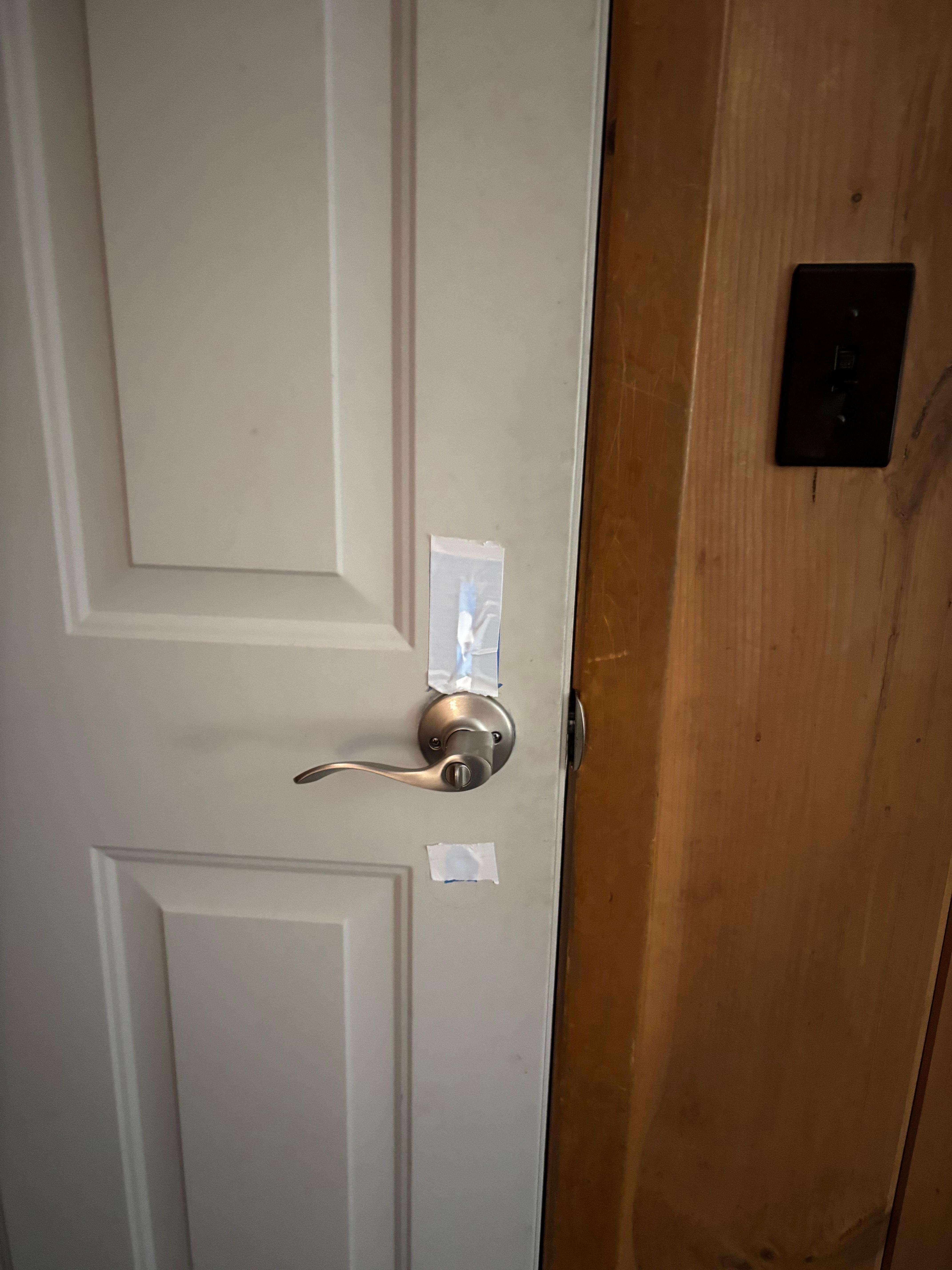Front door. Duct tape on both sides of door where deadbolt should have been. Interior door handle