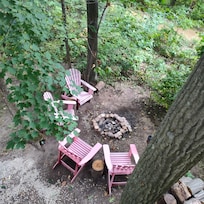 The view of the fire pit from the tree house. To the left are cameras on the post that could be reviewed by them to see how their dog behaved.