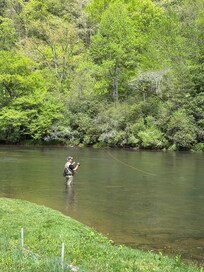 Husband fly fishing right in front of the cabin