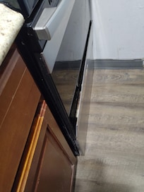 Trim panel broken loose from oven door