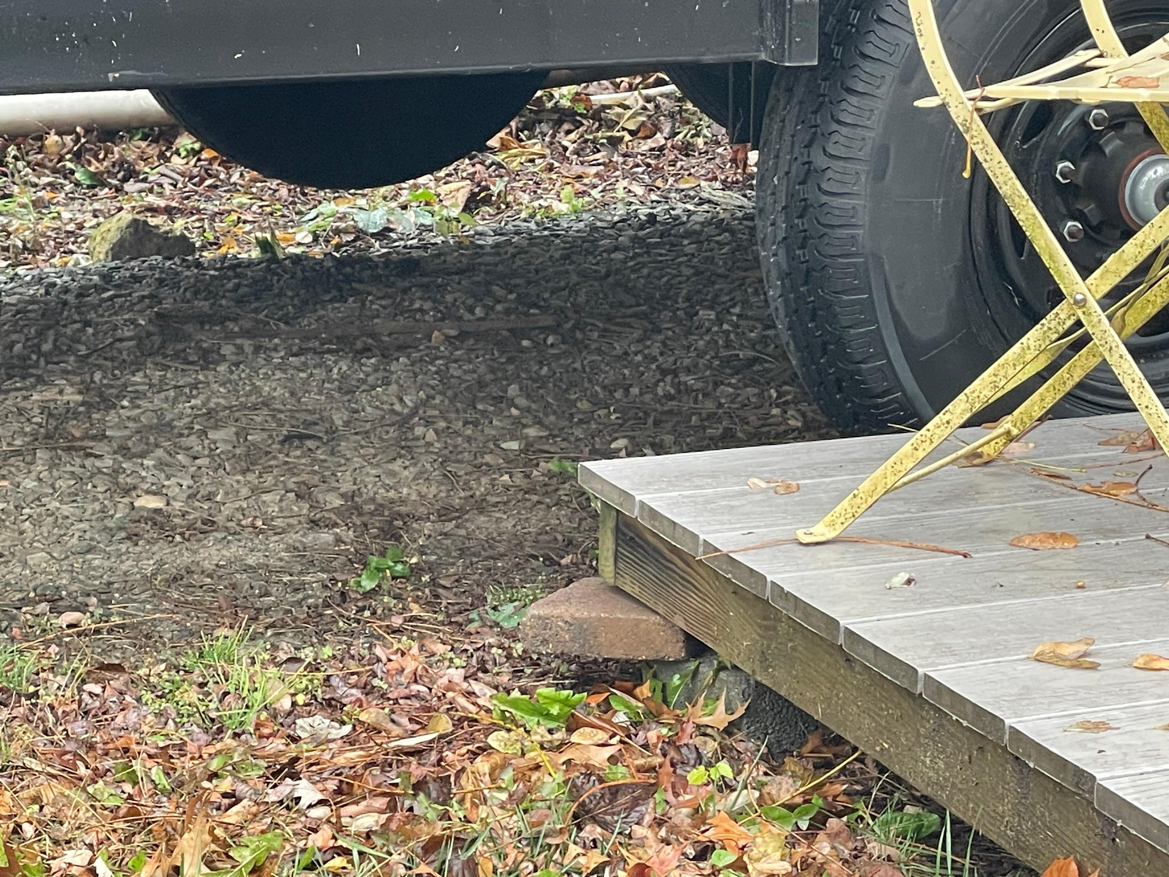 Porch poorly supported with uneven ground to step onto first landing. 5 steps to enter without safety rail.