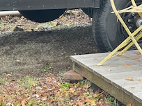 Porch poorly supported with uneven ground to step onto first landing. 5 steps to enter without safety rail.