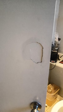 Hole in the bathroom door.