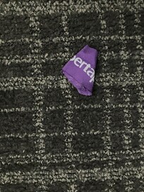 Hospital bandage left on carpet under bed