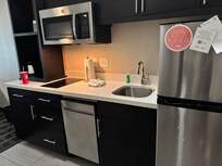 The kitchen. Includes utensils, cookware, dishes, glasses and a nice size refrigerator…Home away from home.