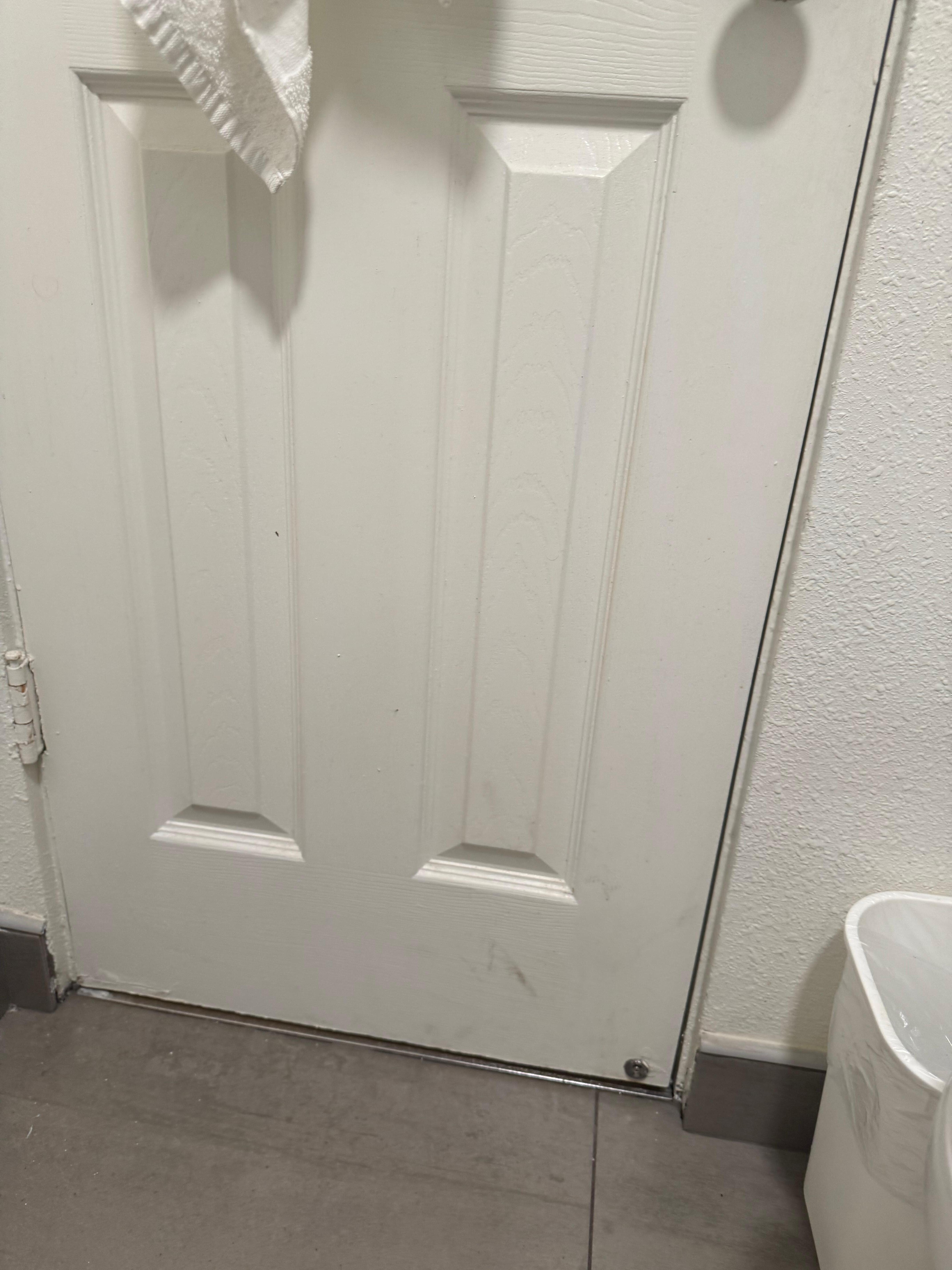 Dirty bathroom w/ broken door