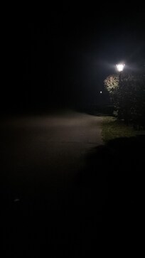 Very dark pathway walking between the building my coworkers were in and the main building.