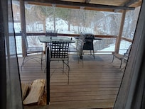 View from inside house to porch overlooking creek