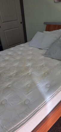 Upstairs bedroom mattress had urine stains.