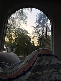 Morning on the enclosed front porch bed swing.