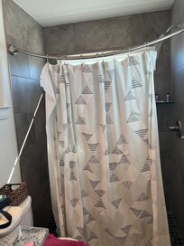 There’s no way to keep the curtain stretched out, keeping the water off the floor