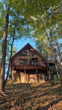 Outside of house. Deck off of living room. Deck with hot tub to right in the picture - off of main door to cabin.