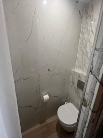 Toilet right near the bed without any partitions