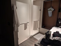 There's no bath "room". These stalls face the bed, partially blocked by sink n mirror.