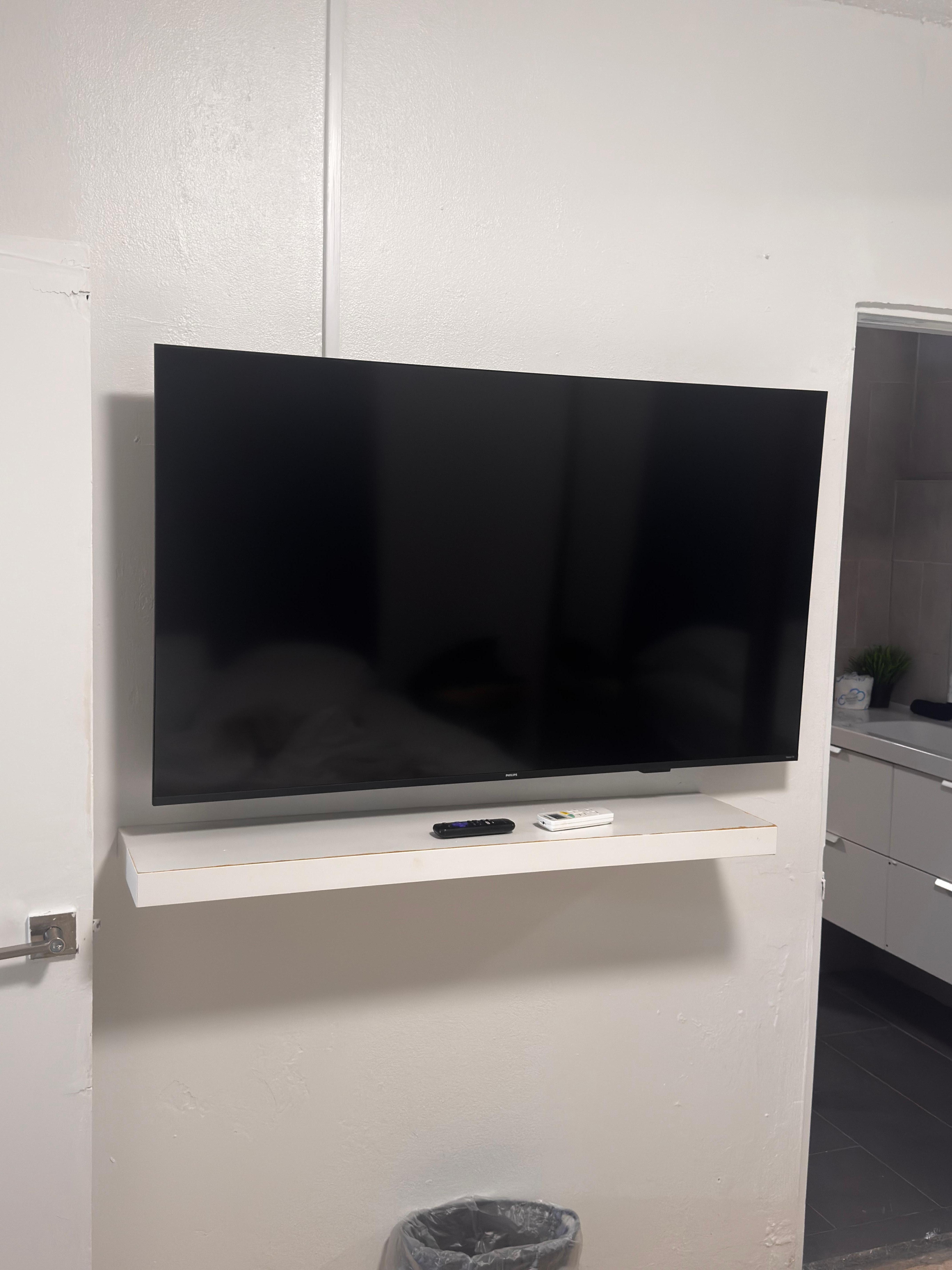 TV mounted offset from stand. 