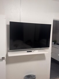 TV mounted offset from stand.