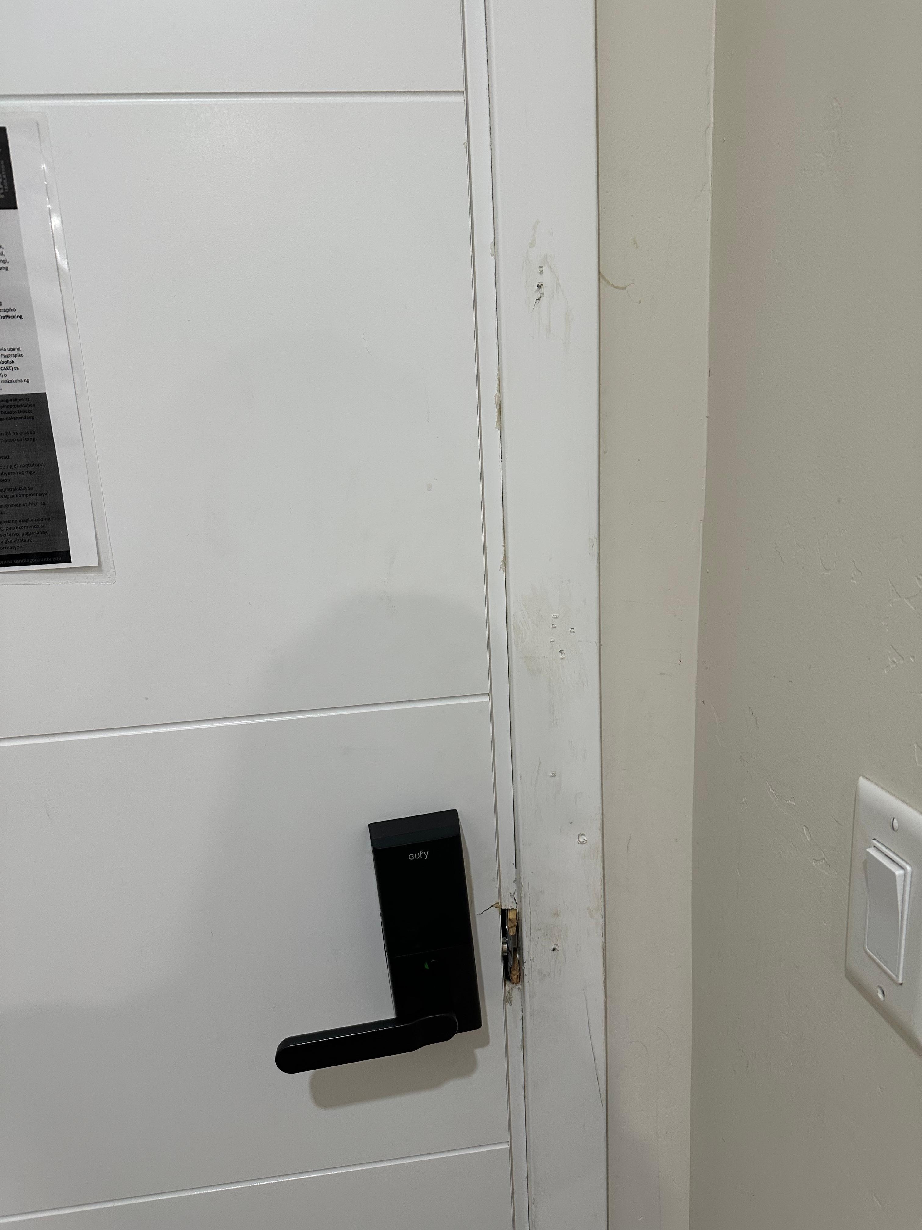 Entry door to the room that appears to have been kicked in at some point. 