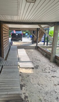 Under house where you walk to access back house, pool, storage