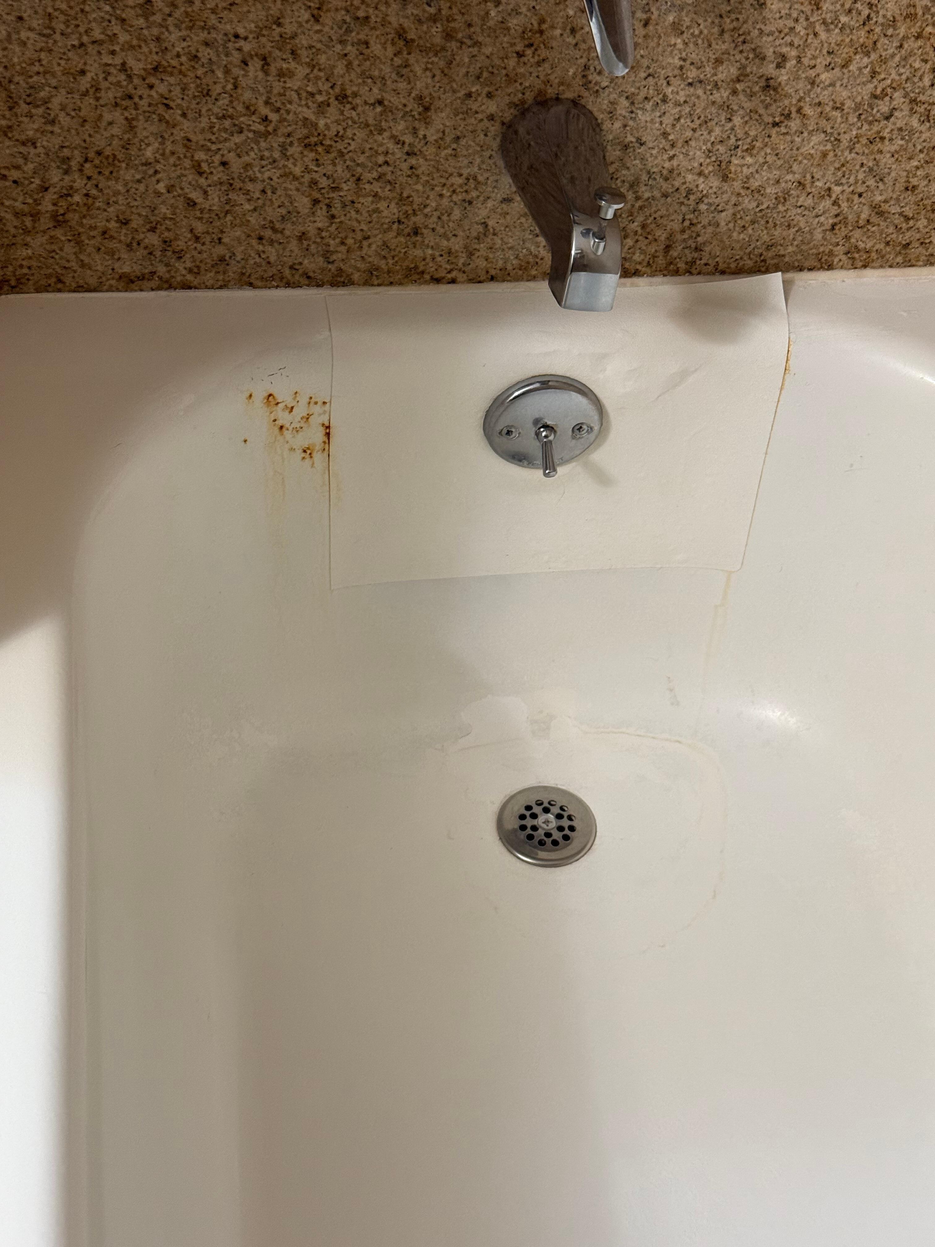 Rusted bathtubs with paper/stickers covering