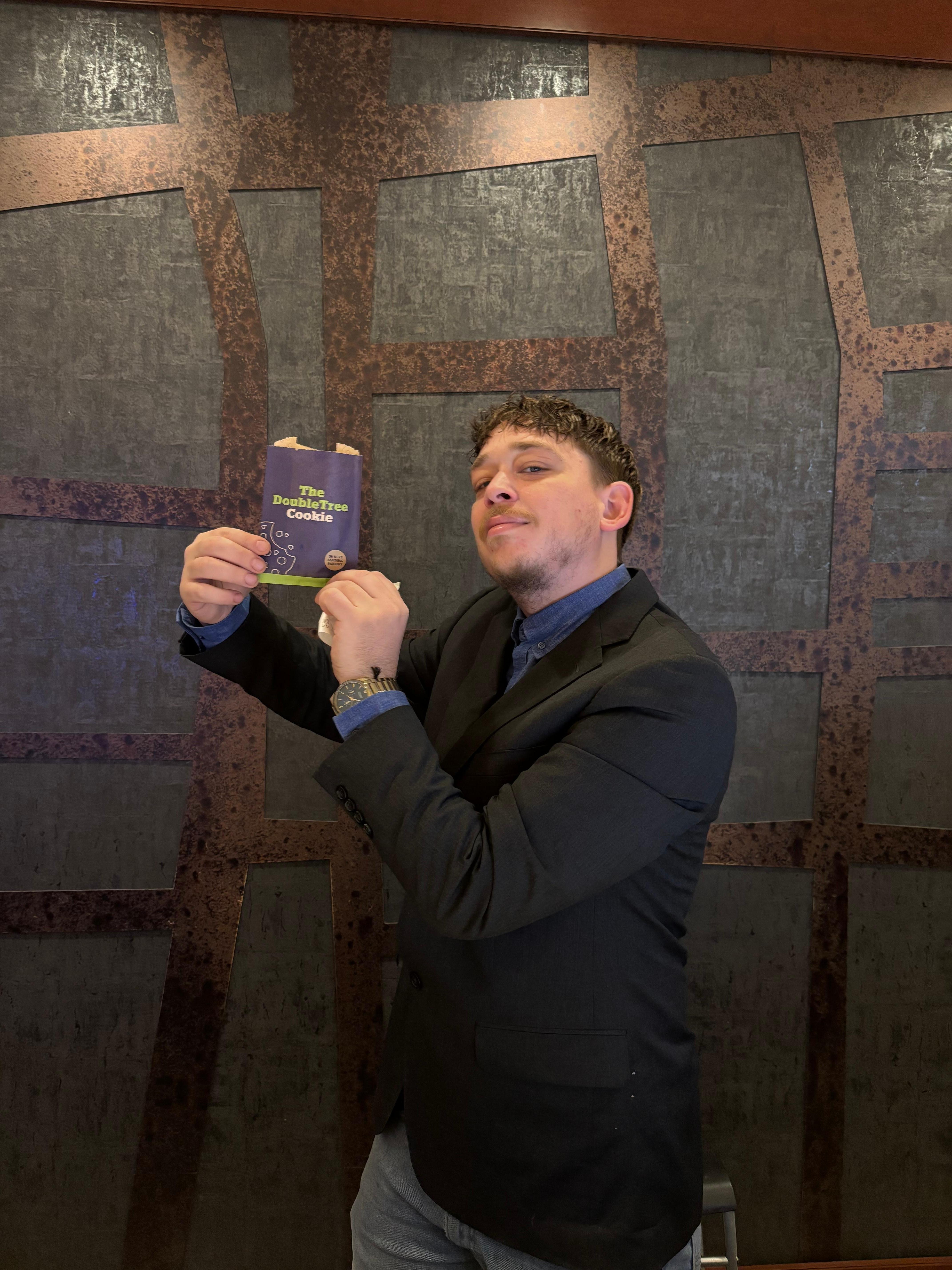 Joshua at DoubleTree front desk offering the famous and warm DoubleTree cookies!   