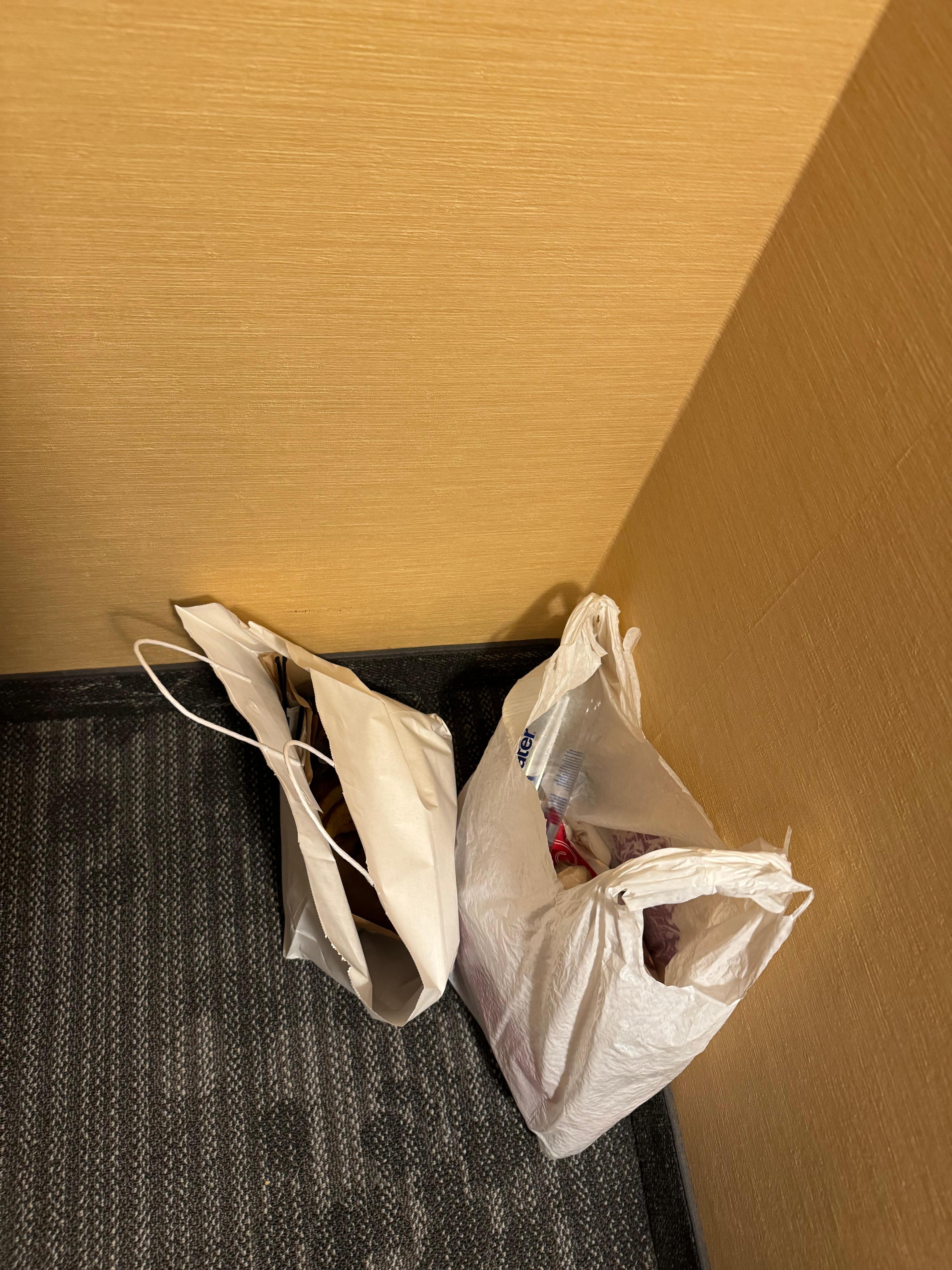 Food trash hidden behind a chair from previous guest. 