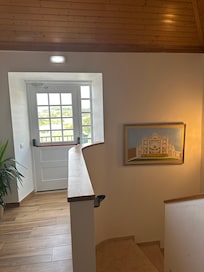 Hallway landing and door to balcony.