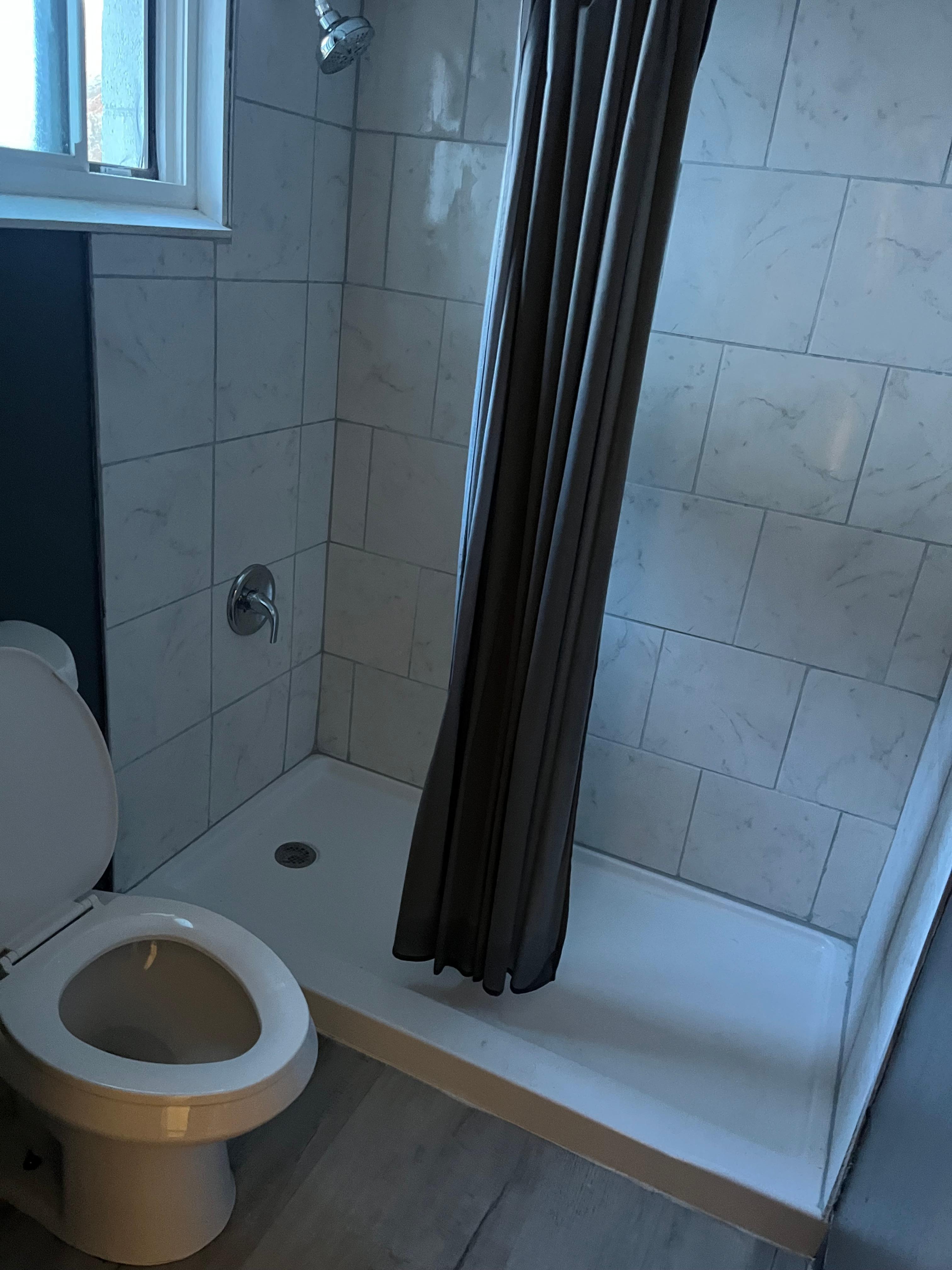 Shower curtain is in the shower with you very little space 