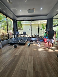 Gym: Buckets collecting water from the leaking ceiling.