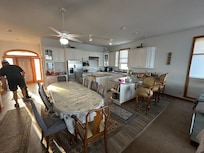 The rugs are glued down in the kitchen and dining area to cover missing or damaged vinyl flooring planks.