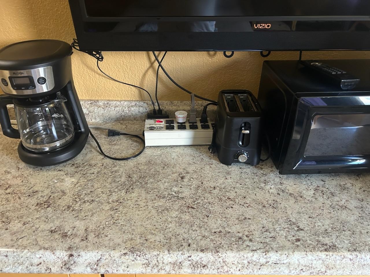 Overloaded circuit with TV, microwave, coffee maker, toaster, and dual coil hotplate all expected to be plugged into one outlet.