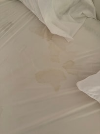 Dried blood stains on several bedding covers