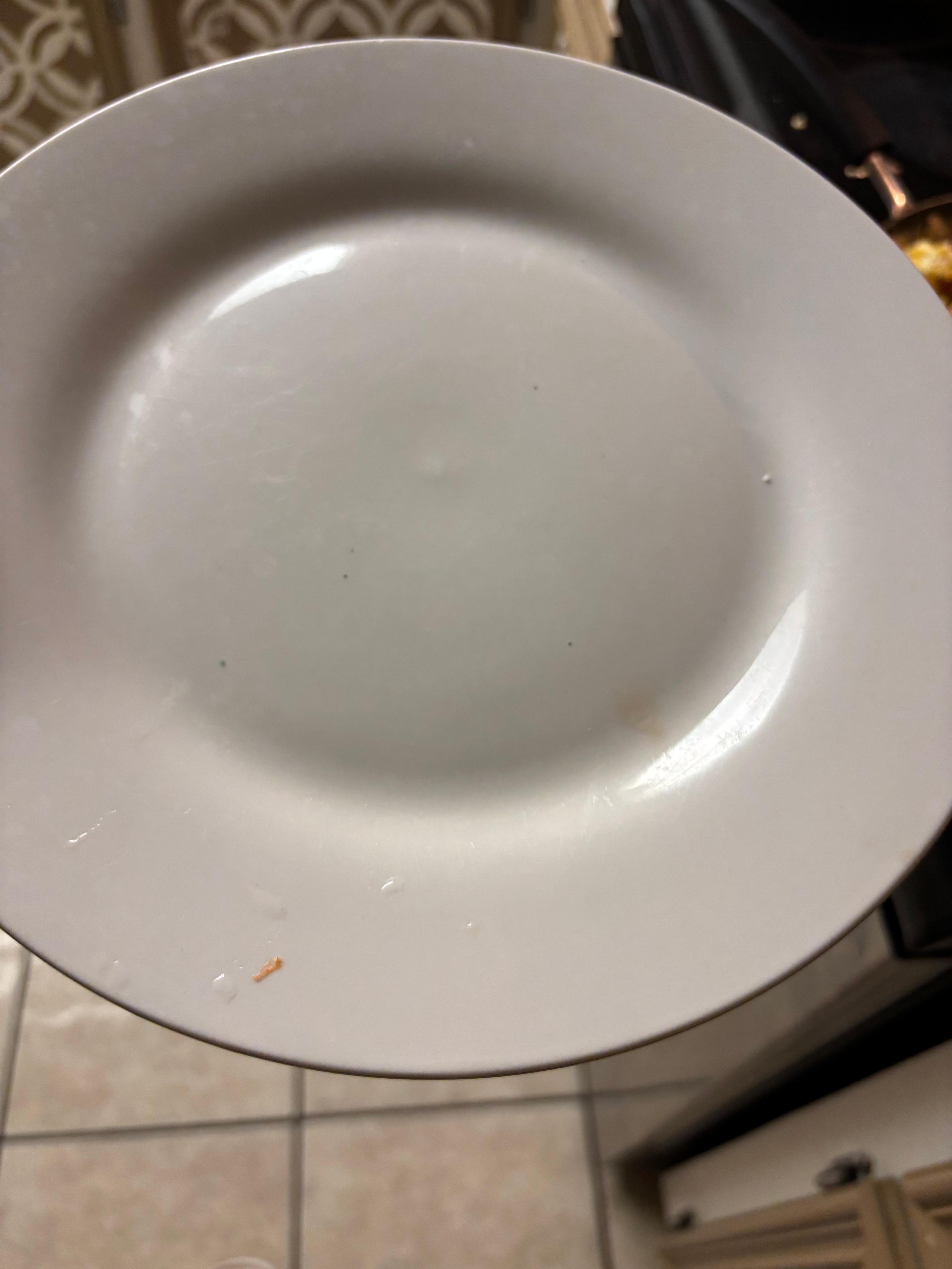 One of the many plates with stains and food residue 