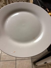 One of the many plates with stains and food residue