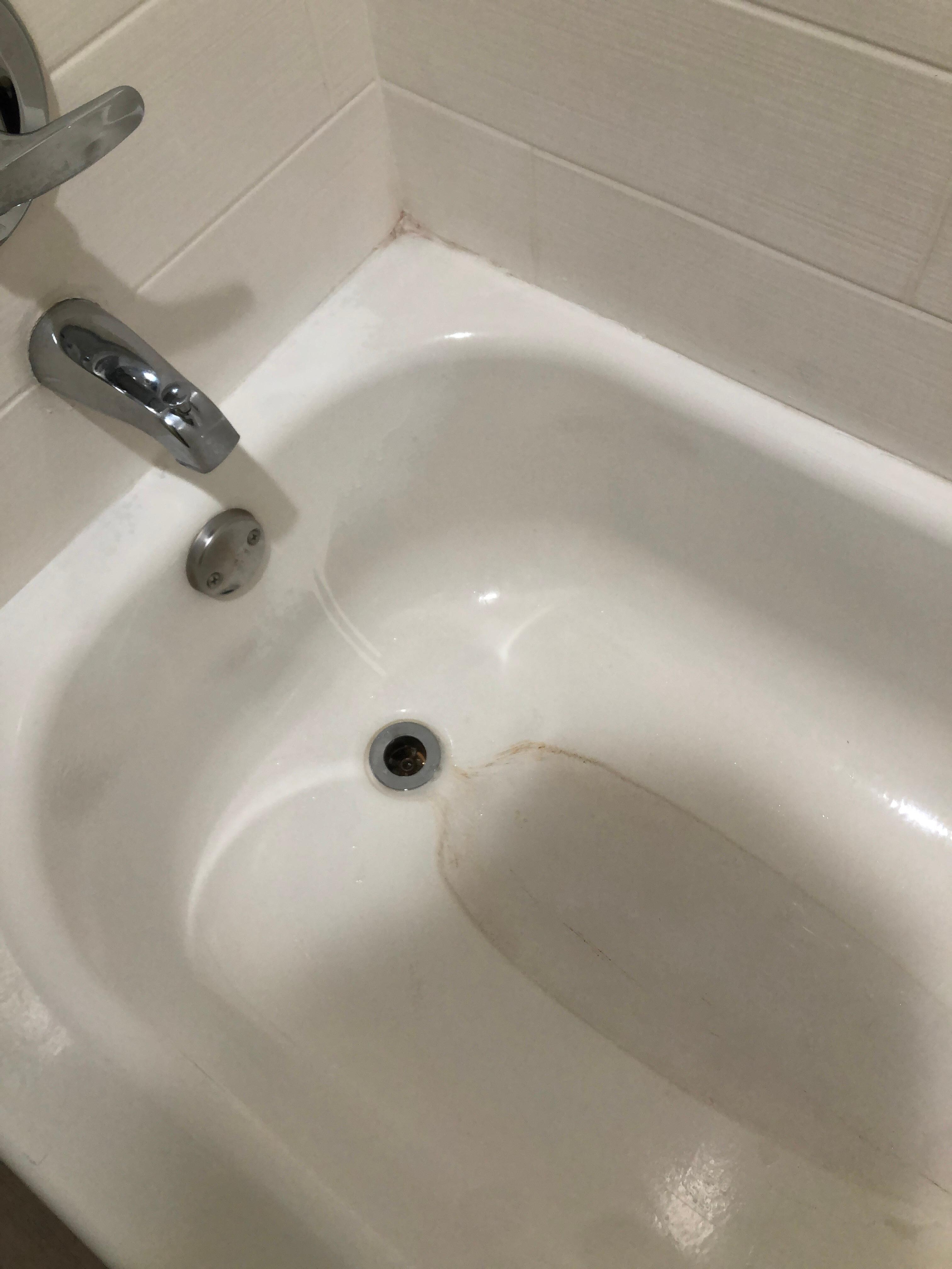 Stained tub with some pink mold
