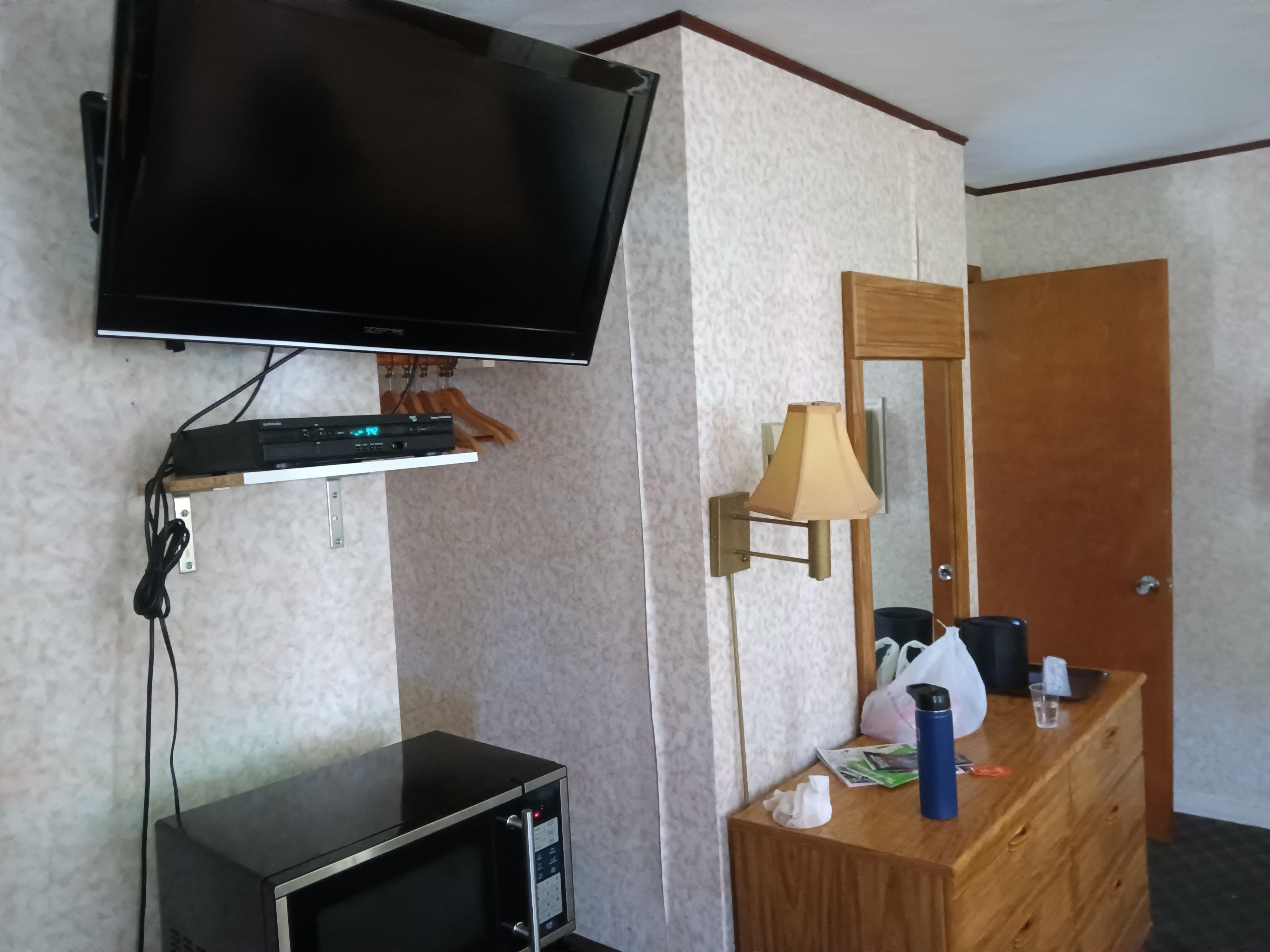 TV, Microwave and a Fridge underneath