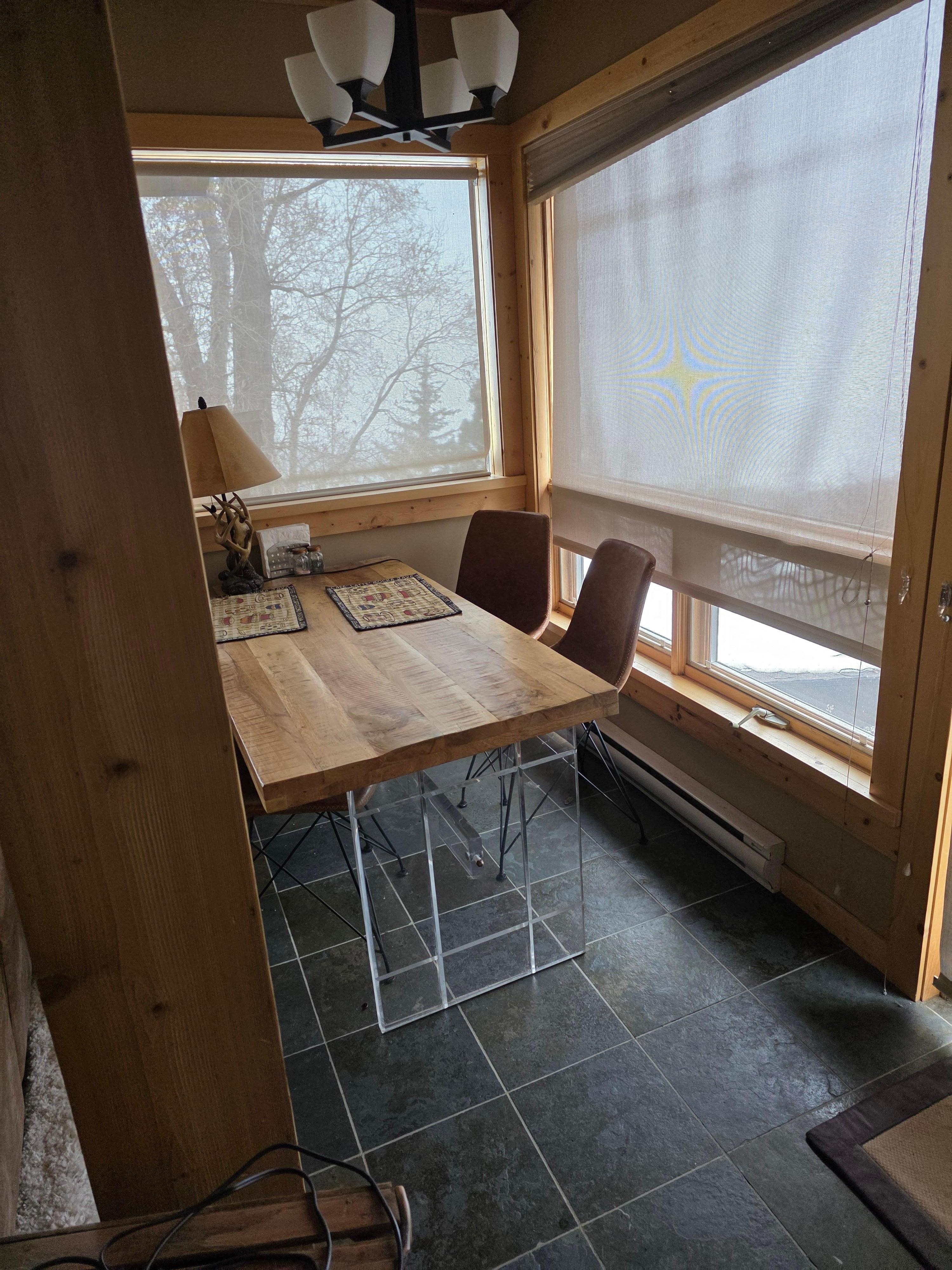 Across from the twin Murphy bed on the other side of the double doors to the porch.